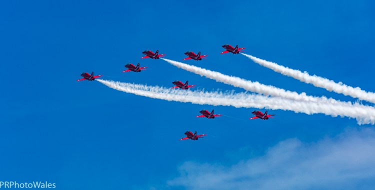 The RAF display team, the Red Arrows performing their thrilling aerobatic display at Swansea seafront on July 2nd, 2017. Here flying in formation, up and away to towards 11 o'clock. Three are trailing white smoke.