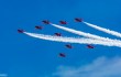 The RAF display team, the Red Arrows performing their thrilling aerobatic display at Swansea seafront on July 2nd, 2017. Here flying in formation, up and away to towards 11 o'clock. Three are trailing white smoke.