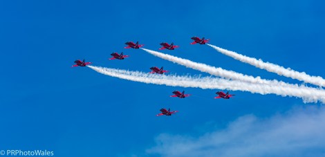 The RAF display team, the Red Arrows performing their thrilling aerobatic display at Swansea seafront on July 2nd, 2017. Here flying in formation, up and away to towards 11 o'clock. Three are trailing white smoke.