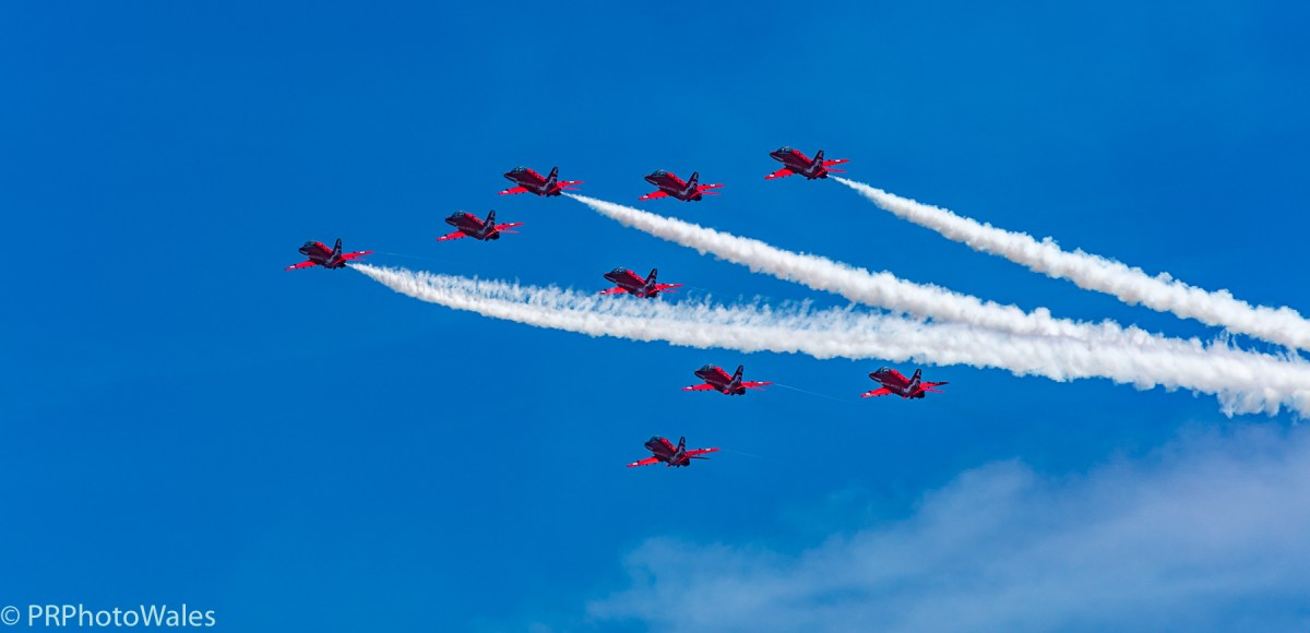 The RAF display team, the Red Arrows performing their thrilling aerobatic display at Swansea seafront on July 2nd, 2017. Here flying in formation, up and away to towards 11 o'clock. Three are trailing white smoke.